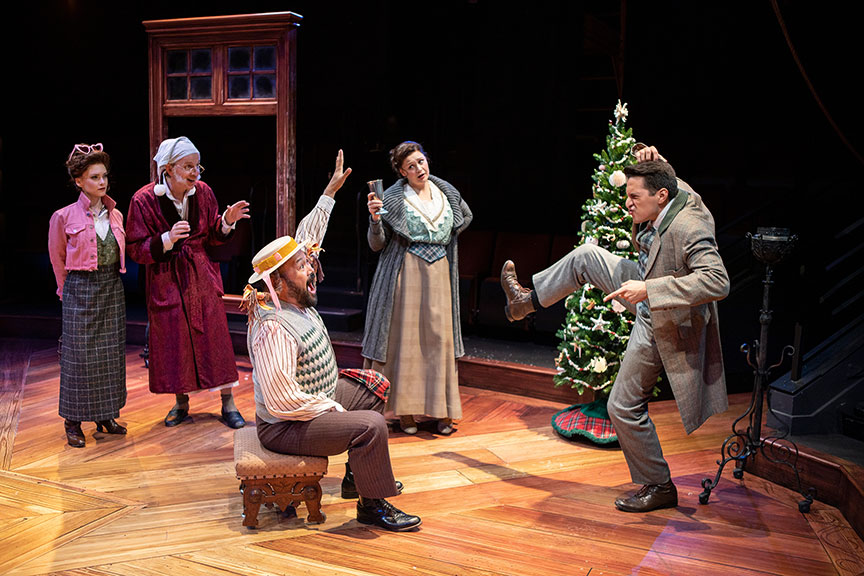 Cathryn Wake as Ghost of Christmas Present, Robert Joy as Ebenezer Scrooge, Orville Mendoza as Jack, Jacque Wilke as Jennie, and Dan Rosales as Fred. Ebenezer Scrooge's BIG San Diego Christmas Show runs November 23 – December 29, 2019 at The Old Globe. Photo by Jim Cox.