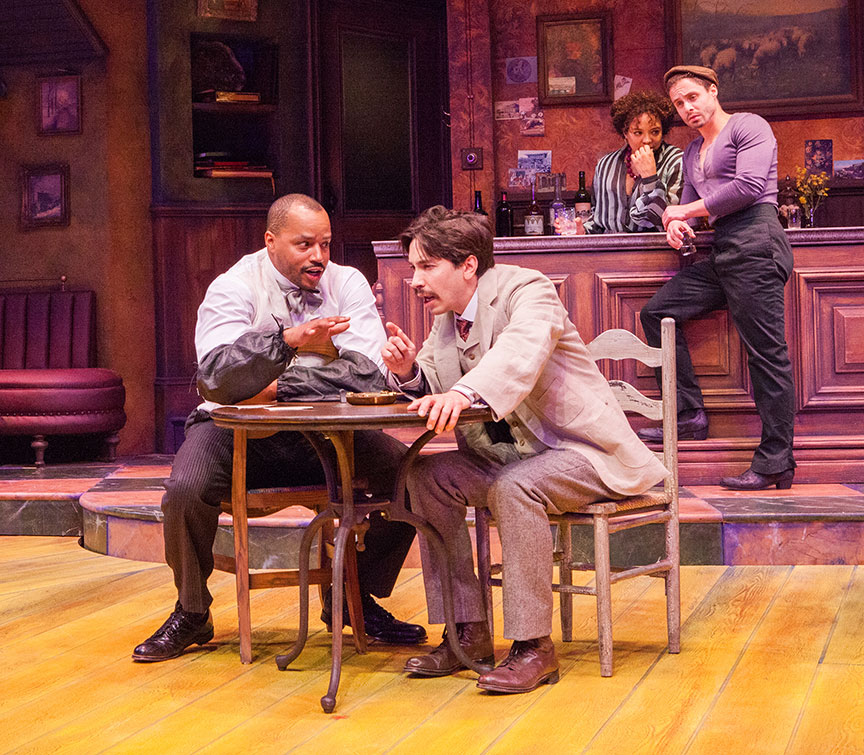 (from left) Donald Faison as Freddy, Justin Long as Albert Einstein, Luna Veléz as Germaine, and Philippe Bowgen as Pablo Picasso in Picasso at the Lapin Agile, by Steve Martin, directed by Barry Edelstein, running February 4 - March 12, 2017 at The Old Globe. Photo by Jim Cox.