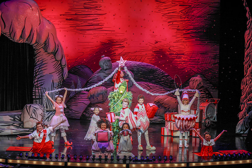 (center) Andrew Polec as The Grinch with the Little Who Ensemble of Dr. Seuss’s How the Grinch Stole Christmas!, 2023. Photo by Jim Cox.