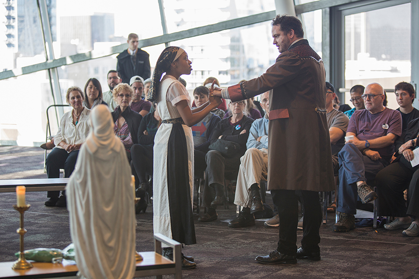 (from left) Makha Mthembu as Isabella and Jake Millgard as Lucio performing for the audience from the San Diego Library, Central Branch. The 2016 production of The Old Globe's touring program Globe for All, Shakespeare's Measure for Measure, directed by Patricia McGregor, tours community venues Nov. 1 - 20. Photo by Jim Cox. 