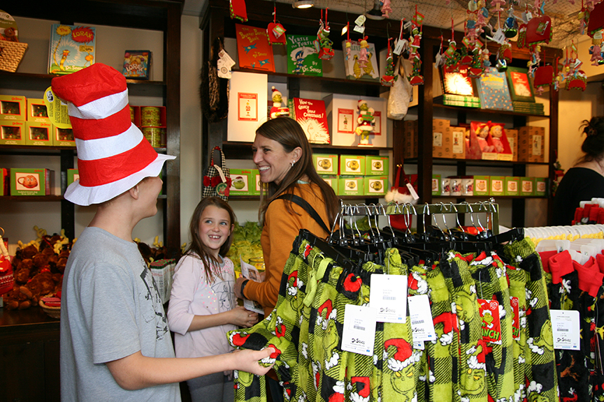 Shoppers Grayson Coons, Sophie Coons and Kellie Coons shop for Grinch-y must-haves at the Helen Edison Gift Shop. Photo by Lucía Serrano.
