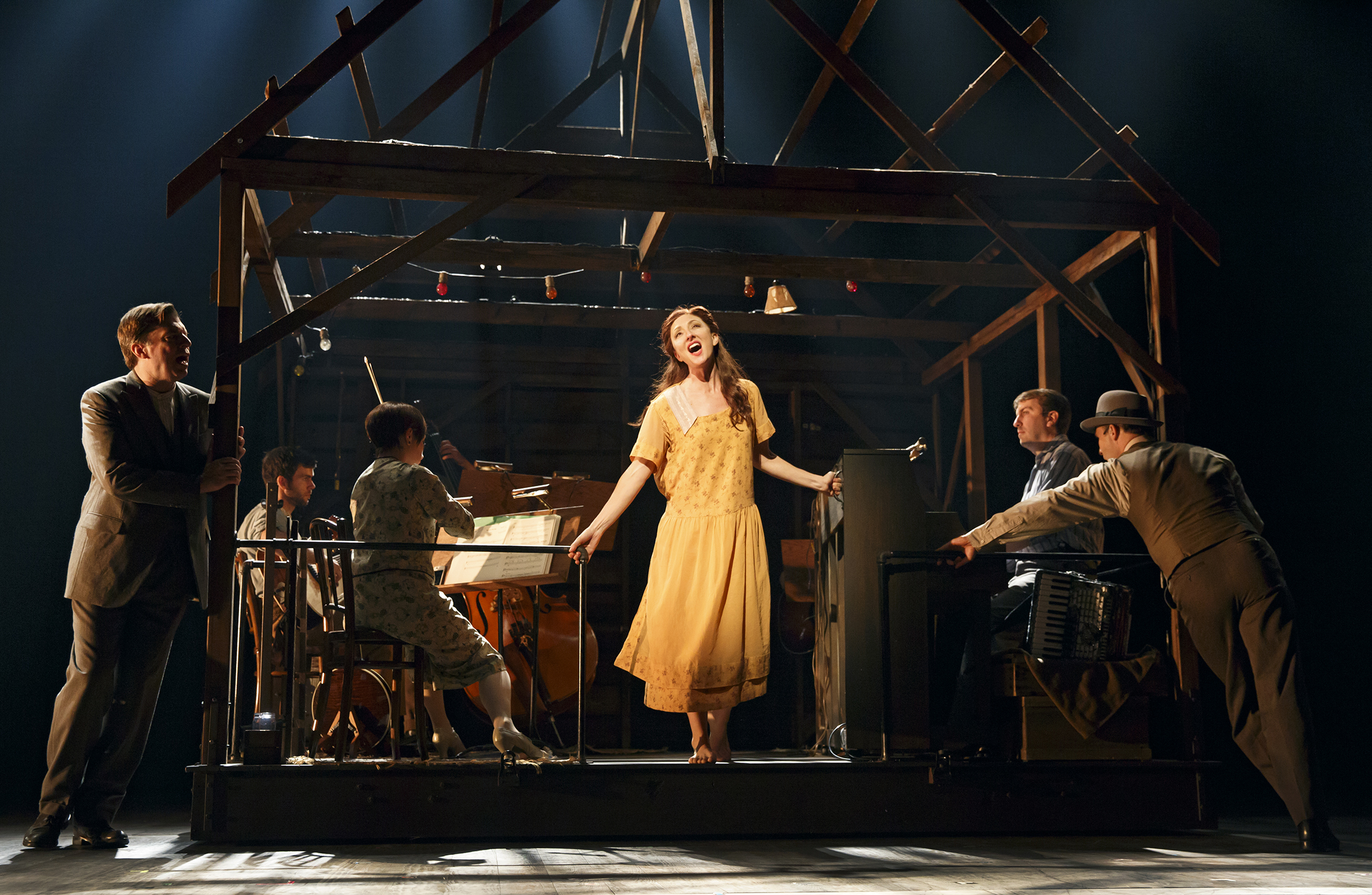(foreground) Carmen Cusack as Alice Murphy with (from left) Scott Wakefield and Joe Jung and the orchestra of the world premiere of Bright Star, a new American musical with music by Steve Martin and Edie Brickell, lyrics by Brickell, book by Martin, based on an original story by Martin and Brickell, and directed by Tony Award winner Walter Bobbie, Sept. 14 - Nov. 2, 2014 at The Old Globe. Photo by Joan Marcus.