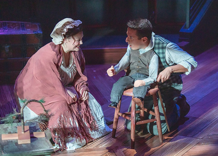 Jacque Wilke as Mrs. Cratchit and Dan Rosales as Tiny Tim. Ebenezer Scrooge's BIG San Diego Christmas Show runs November 23 – December 29, 2019 at The Old Globe. Photo by Jim Cox.