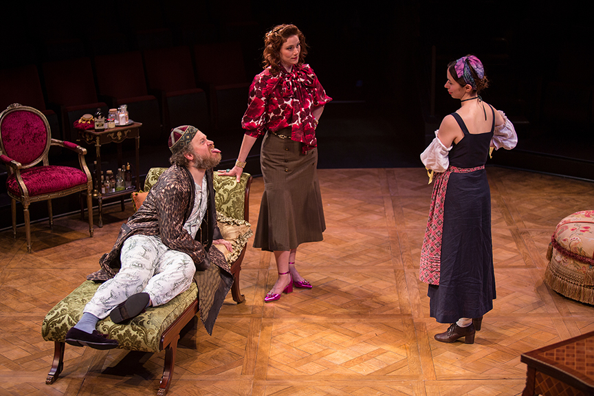 (from left) Andy Grotelueschen appears as Argan, Jessie Austrian as Béline, and Emily Young as Toinette in the world premiere adaptation of Molière’s The Imaginary Invalid, adapted by Fiasco Theater, running May 27 – June 25, 2017 at The Old Globe. Photo by Jim Cox.