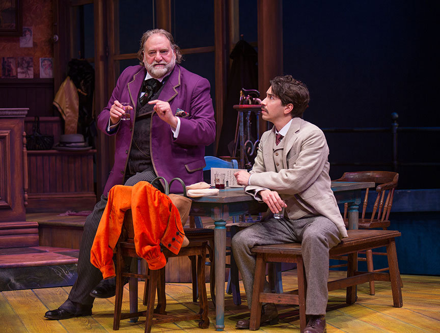 (from left) Ron Orbach as Sagot and Justin Long as Albert Einstein in Picasso at the Lapin Agile, by Steve Martin, directed by Barry Edelstein, running February 4 - March 12, 2017 at The Old Globe. Photo by Jim Cox.