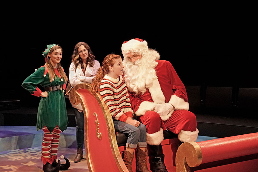 (from left) Katie Sapper as Ensemble, Liana Hunt as Jessie Randolf, Kaylin Hedges as Ellie Randolf, and Bryant Martin as Santa in Clint Black's Looking for Christmas, running November 11 – December 31, 2018 at The Old Globe. Photo by Ken Howard.
