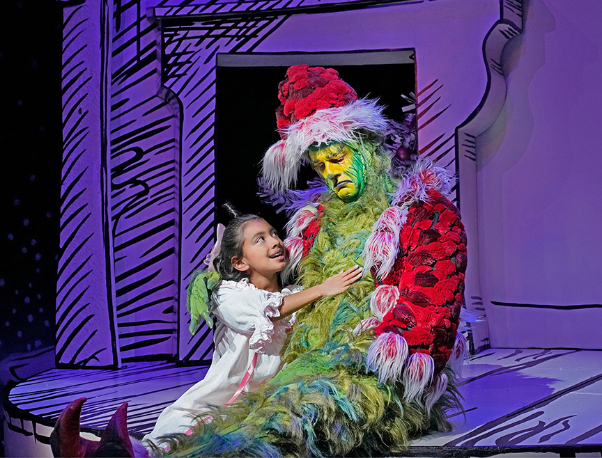 Leila Manuel appears as Cindy-Lou Who and Edward Watts as The Grinch in Dr. Seuss's How the Grinch Stole Christmas!, 2018. Book and lyrics by Timothy Mason, music by Mel Marvin, original production conceived and directed by Jack O'Brien, original choreography by John DeLuca, and directed by James Vásquez, running November 10 – December 29, 2019 at The Old Globe. Photo by Ken Howard.