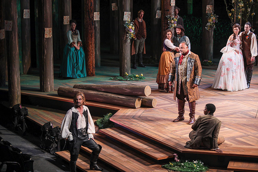 Mark H. Dold as Jaques (left) and Cornell Womack as Duke Senior (center) with the cast of As You Like It, by William Shakespeare, directed by Jessica Stone, running June 16 – July 21, 2019 at The Old Globe. Photo by Jim Cox.