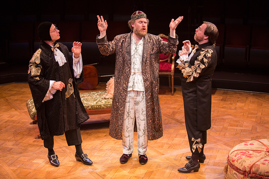 (from left) Noah Brody appears as Dr. Diafoirus, Andy Grotelueschen as Argan, and Paul L. Coffey as Thomas Diafoirus in the world premiere adaptation of Molière’s The Imaginary Invalid, adapted by Fiasco Theater, running May 27 – June 25, 2017 at The Old Globe. Photo by Jim Cox.