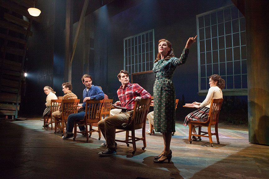 (foreground) Sandra DeNise as Miss Riley with the cast of the West Coast premiere of October Sky, with book by Brian Hill and Aaron Thielen, music and lyrics by Michael Mahler, directed and choreographed by Rachel Rockwell, inspired by the Universal Pictures film and Rocket Boys by Homer H. Hickam, Jr., running Sept. 10 - Oct. 23, 2016 at The Old Globe. Photo by Jim Cox.