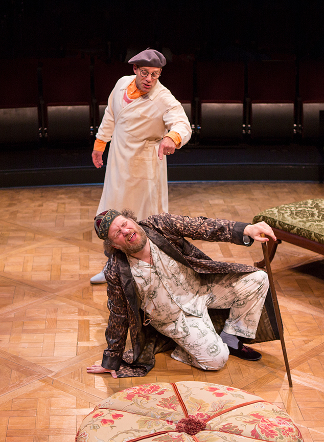 (from left) Noah Brody appears as Dr. Purgon and Andy Grotelueschen as Argan in the world premiere adaptation of Molière’s The Imaginary Invalid, adapted by Fiasco Theater, running May 27 – June 25, 2017 at The Old Globe. Photo by Jim Cox.